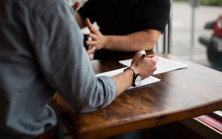 Professionals discussing documents at a table
